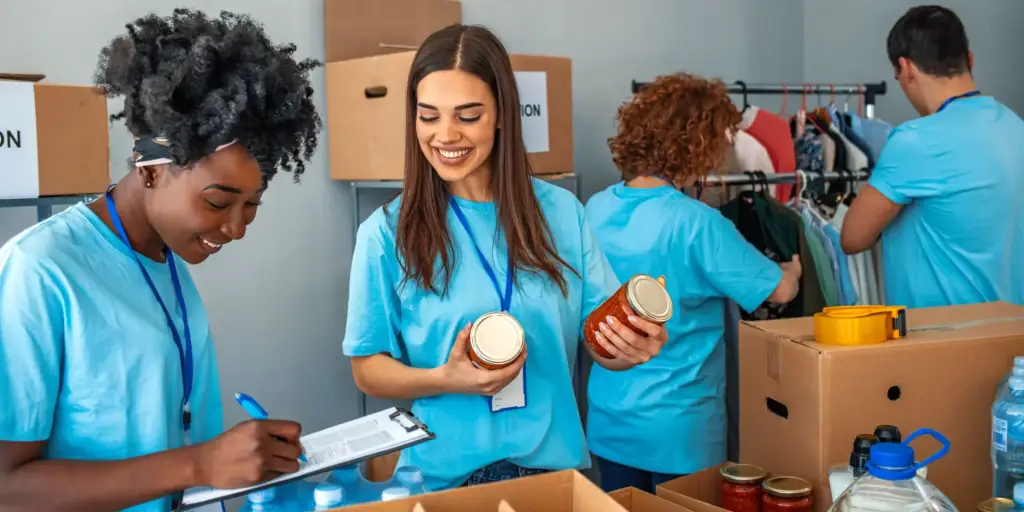 Volunteers working for a nonprofit organization, boxing food ,sorting clothes, etc.