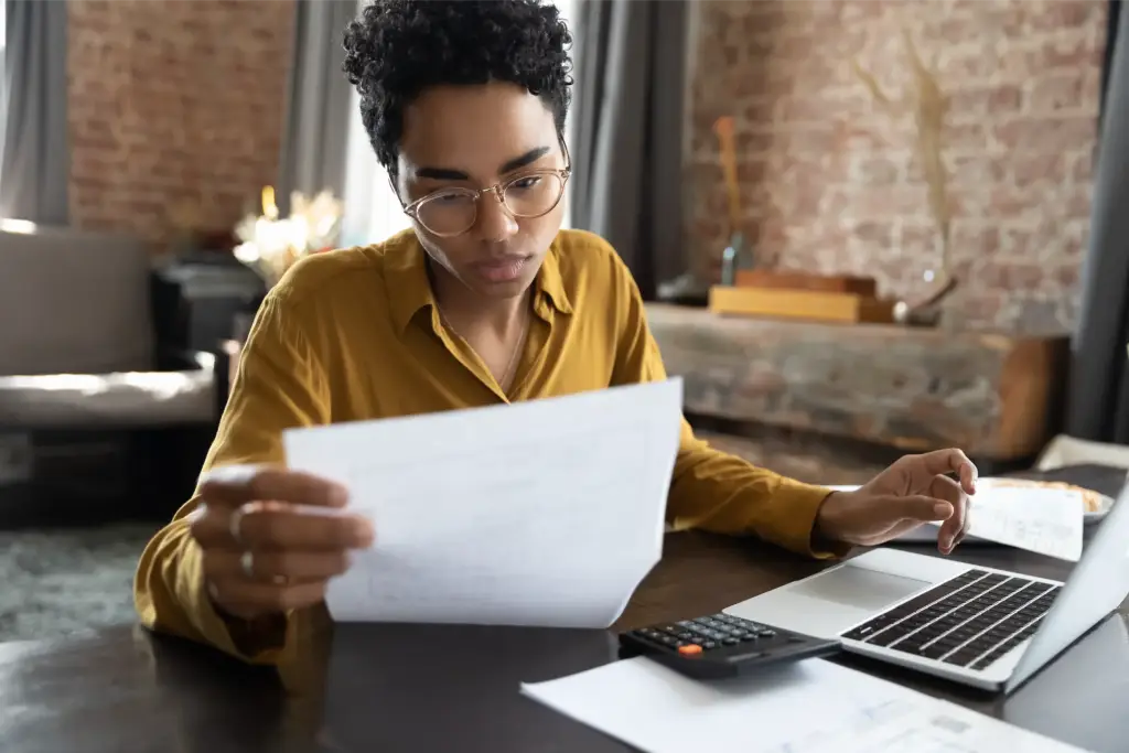 Young woman of color working on tax credits.