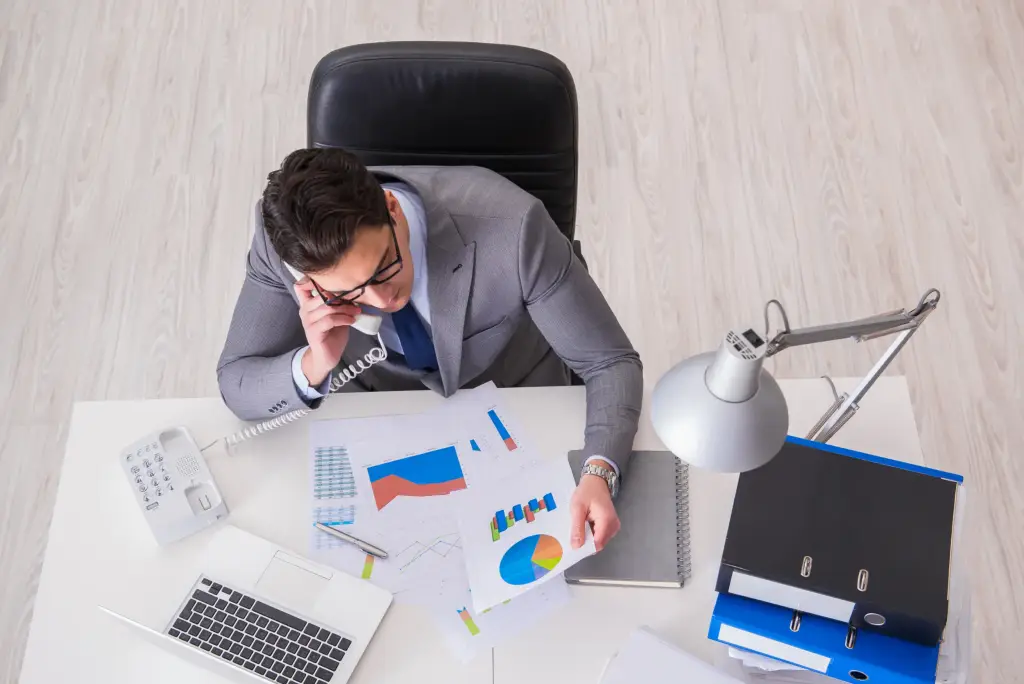 A CFO reviewing analytics while talking on the phone.