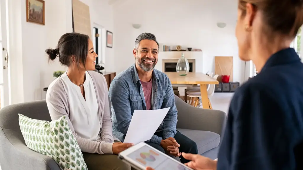 A couple speaking with a financial advisor.
