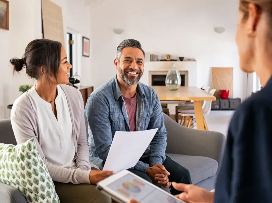 A couple speaking with a financial advisor.